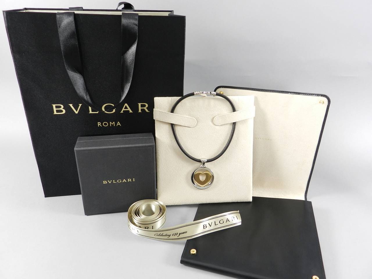 Bvlgari tondo heart necklace. 18k gold, stainless steel, leather cord, and lobster clasp. Comes with all original packaging. Excellent condition. Necklace is 15