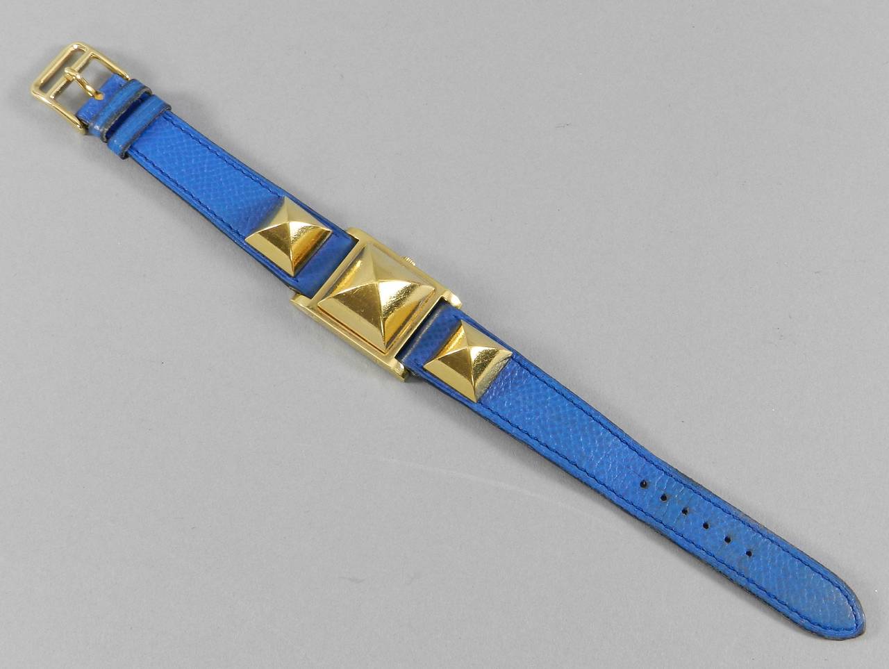 Hermes Medor watch in goldtone metal and blue leather strap. Excellent previously owned condition. Front face measures 7/8