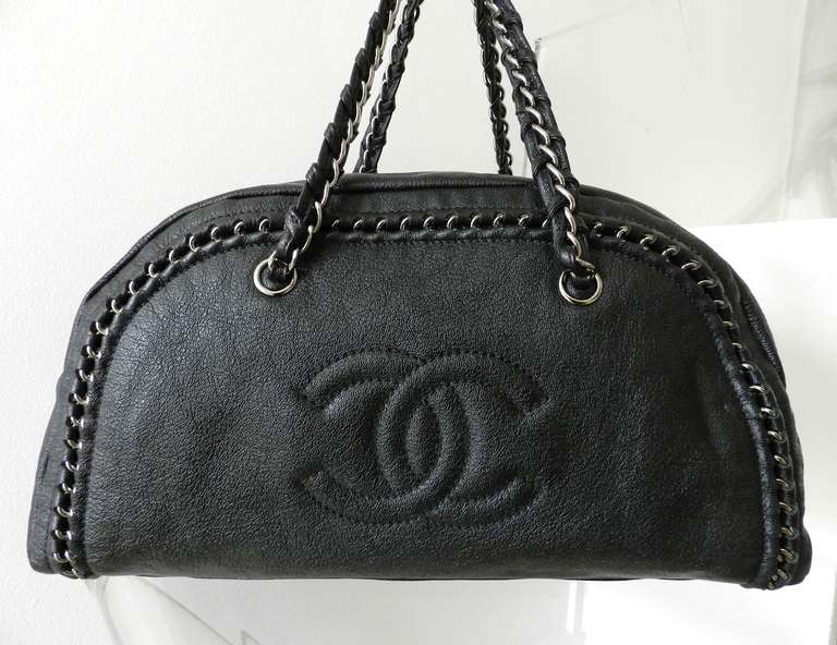 Chanel Luxe Ligne black leather bowler bag with silvertone chain hardware. Body measures about 16