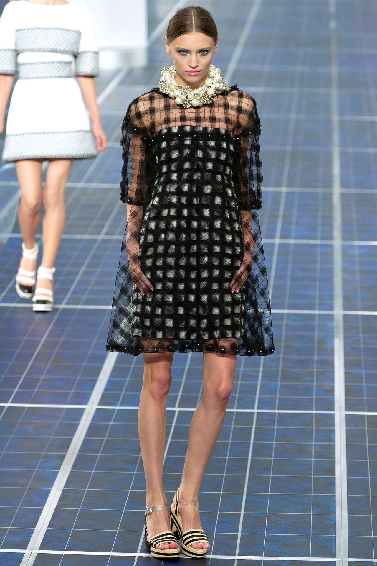 Chanel 2013 Spring runway and ad campaign dress. As shown in runway photos, there is a fitted grey and black silk check strapless dress with a sheer black over-over dress. The ad campaign photo shows only the sheer over-dress. The strapless dress