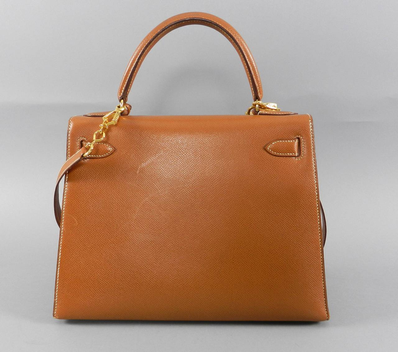 Hermes vintage 1991 tan Kelly 28 cm bag.  Sellier, goldtone hardware, courcheval leather. Comes with shoulder strap, original lock, keys, clochette, duster. This vintage bag has some scuffing across front right side, and bottom centre front. Some