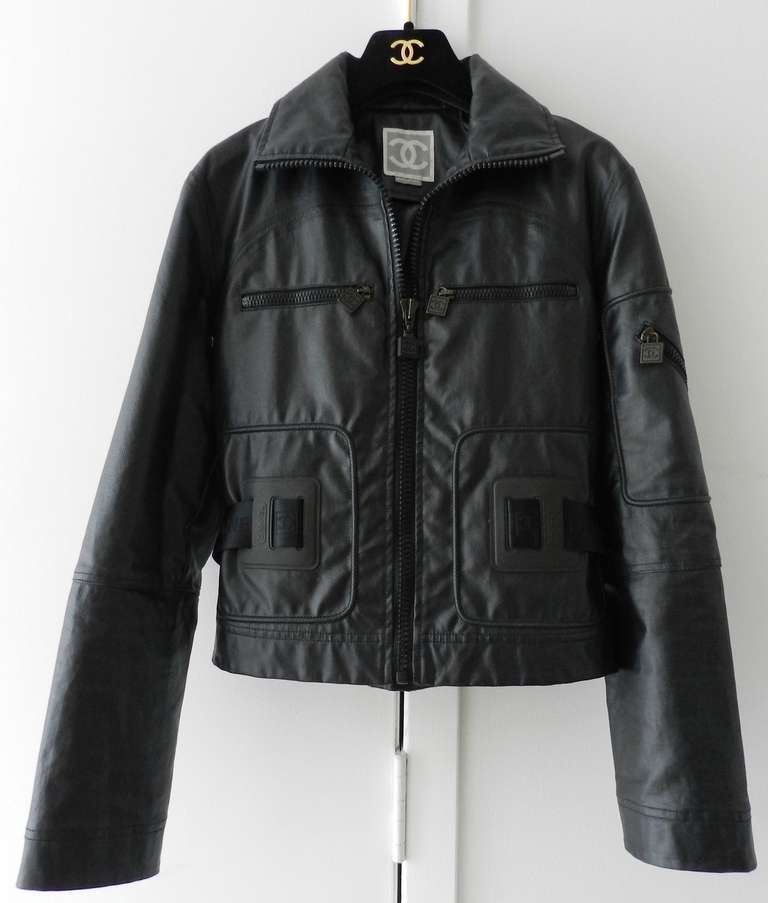 Chanel black rubber polyuerethane jacket from 2004 Spring collection. Large plastic zippers, nylon clip belt, matte black rubber look. Matching skirt is also available in a separate listing. This is for the jacket only. Tagged size Chanel 36 (USA