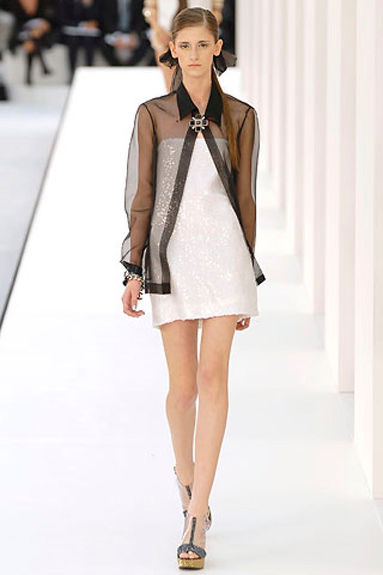 Chanel Spring 2007 runway collection sheer black silk runway jacket. Organza silk, snaps at front with 2 hidden snaps, and buttons up at neck. About a size FR 38 or 40 (USA 6 or 8). Garment measures 38