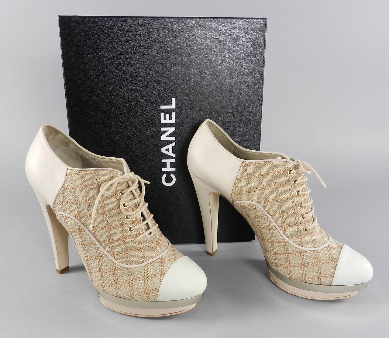 Chanel 2014 spring beige leather linen lace-up booties with gold metallic platform. Never worn. New in box. Anti-slip grips have been professionally added to bottom front sole. Size 41. Interior toe to heel measures 10.5