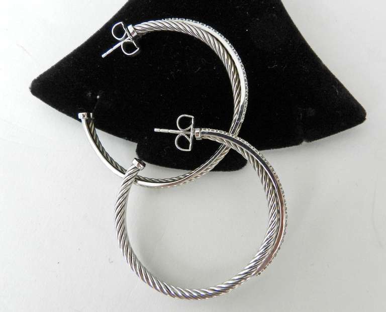 David Yurman XL Crossover Collection Diamond and Sterling Hoop Earrings.  0.65 total carat weight in diamonds, 38mm interior diameter, 44mm exterior diameter.  Original retail $1950+

Shipping prices provided are for FedEx Ground to the USA. For