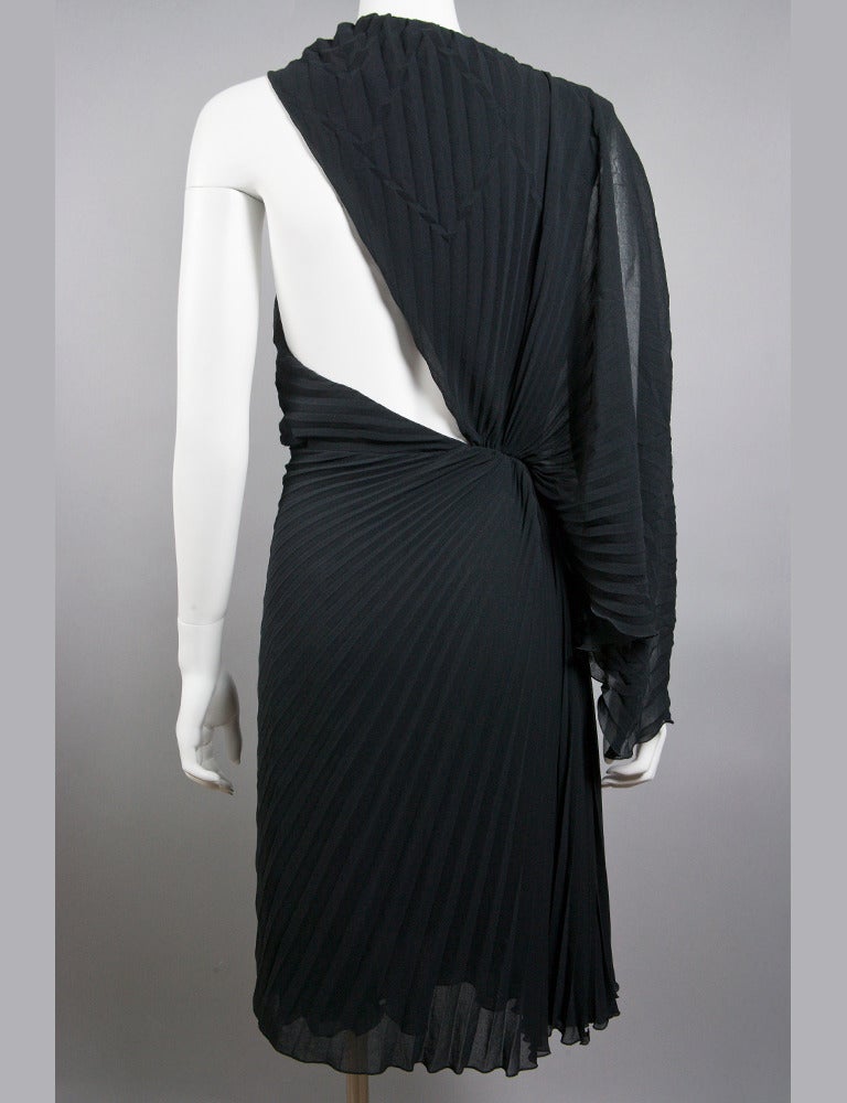 VERSACE collection black one shoulder dress with cut out design. Draped one shoulder sleeve with flat pleats. Dress is tagged size IT 46 (about USA 10/12). 100% poly. Garment measures 30