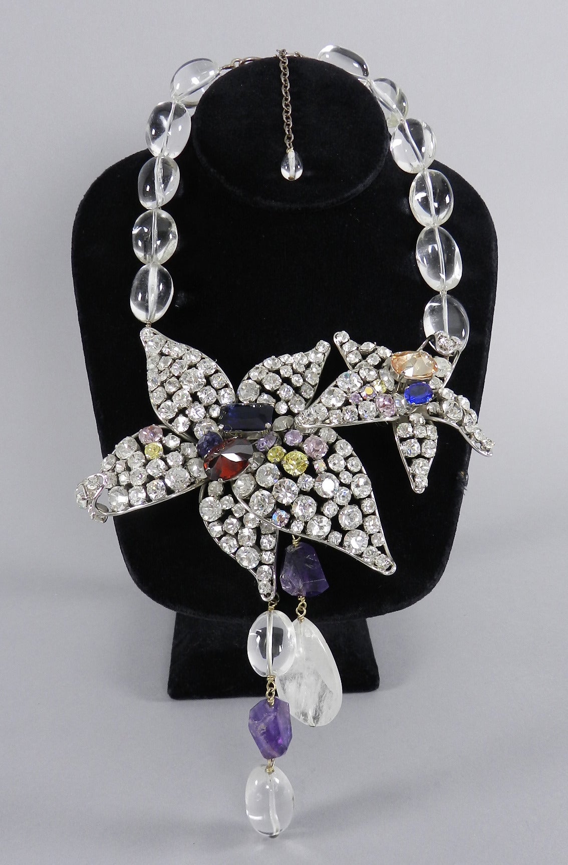 Philipe Ferrandis Paris large rhinestone star statement necklace. Amethyst and rock crystal beads. Clear rhinestones set in silvertone metal with red, blue, topaz, purple, and yellow rhinestones. Necklace adjusts from 16 - 19".  

We ship