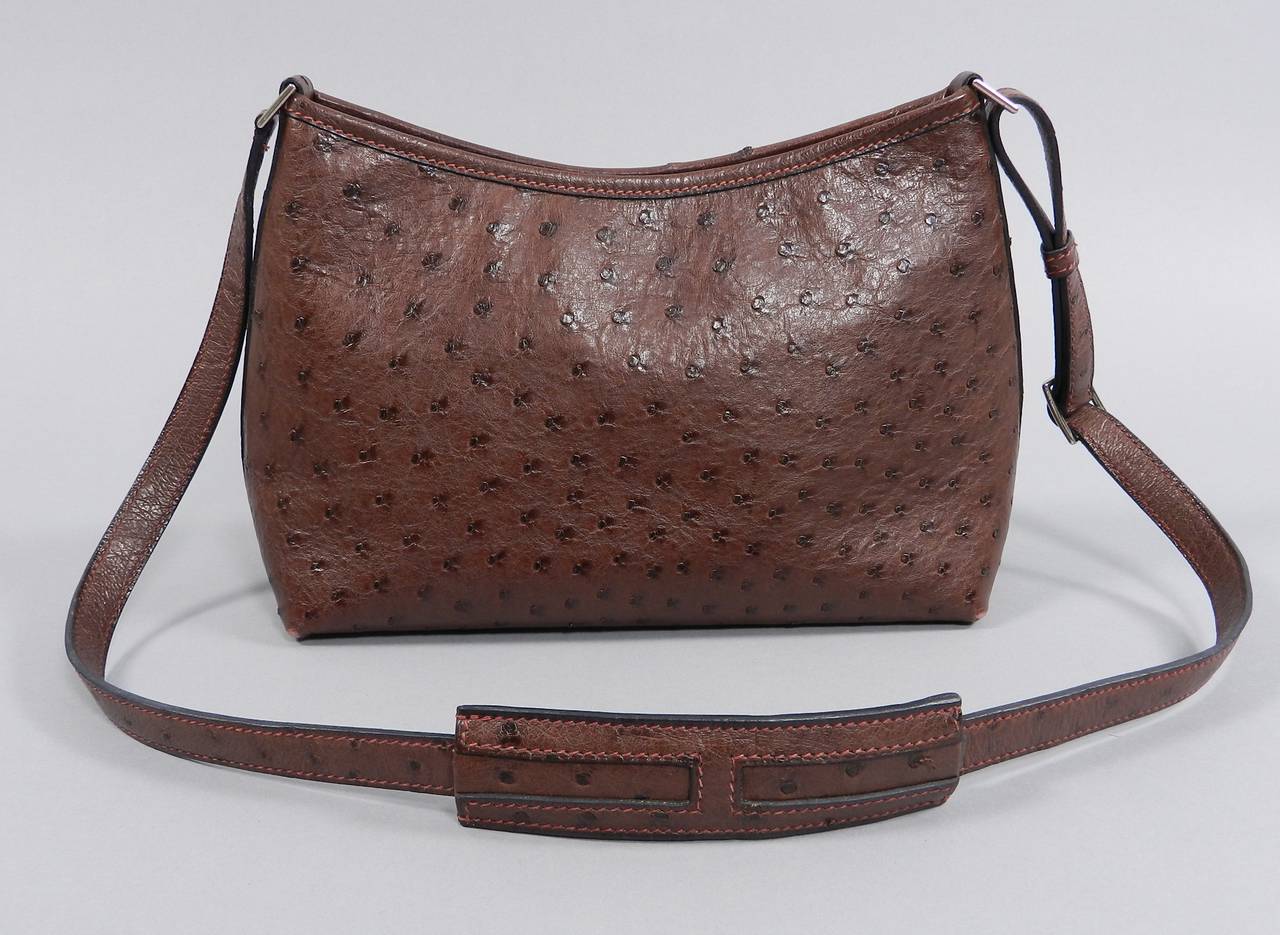 Hermes Berlingot purse in dark wine / burgundy color. Exotic ostrich skin. Adjustable shoulder strap has a maximum 18.5