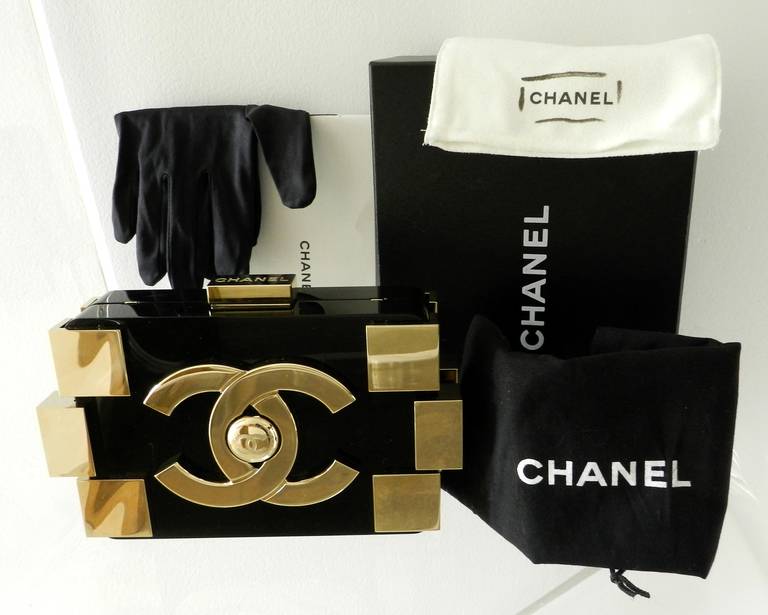 Chanel 2013 collection (17 series) Lego brick minaudiere bag in black and gold. Excellent previously owned condition. Chain can be tucked in to use as a clutch. With box, handling gloves, duster. 

Shipping prices provided are for FedEx Ground to