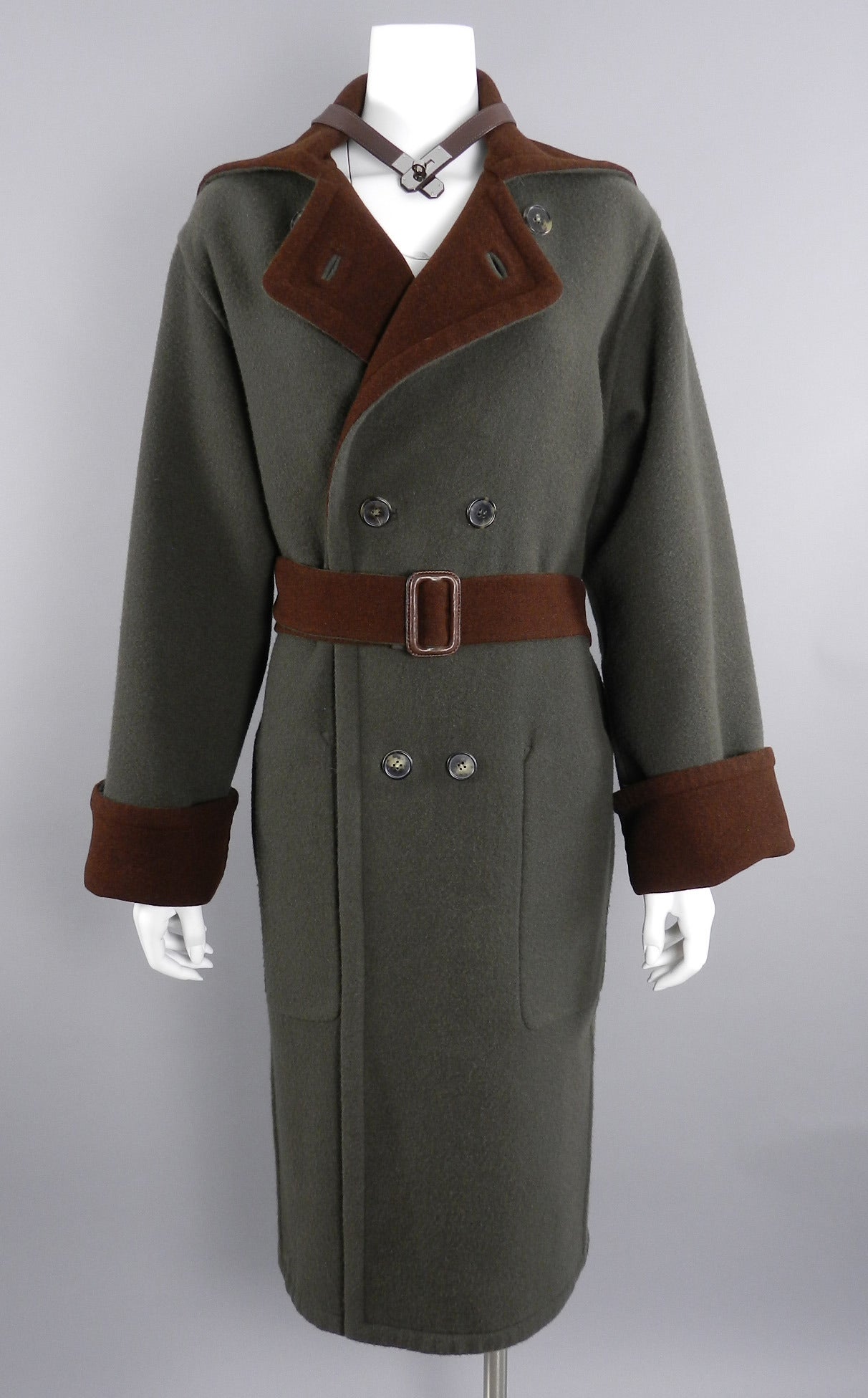 Hermes chocolate brown and dark green wool coat. Has a brown leather Kelly clasp collar that wraps around the collar when fully buttoned up. Garment is fully reversible as it is double faced wool.  Excellent clean condition - worn once if at all.