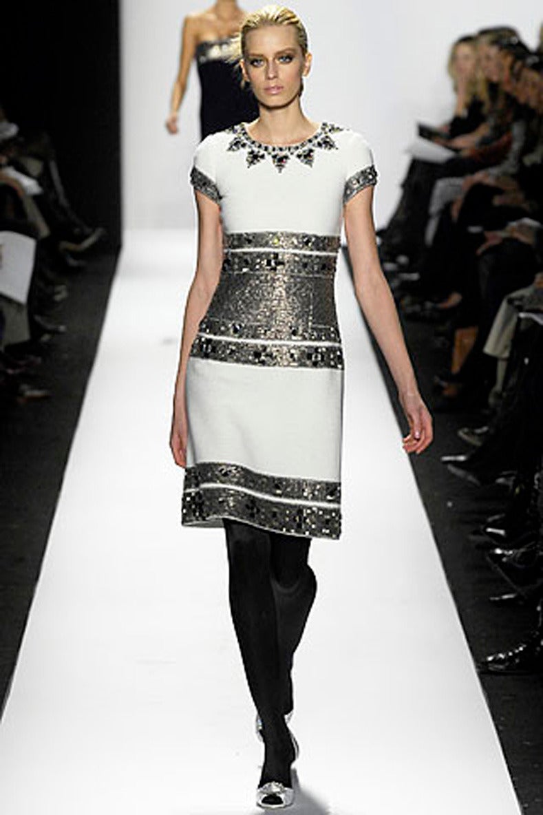 Oscar de la Renta fall 2007 runway collection dress. Ivory wool with silvery sequins and glass beaded embellishment. Short sleeves, invisible centre back zipper, fully lined. Tagged size USA 6. To fit 34 / 35