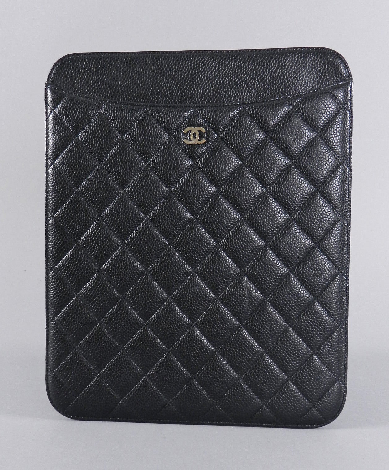 Chanel black caviar ipad case with silvertone CC. Soft burgundy lining. Excellent clean previously owned condition with no flaws. Original card or duster is not present.  Date code 15 series for year 2012.  Measures 10.5 x 8.5