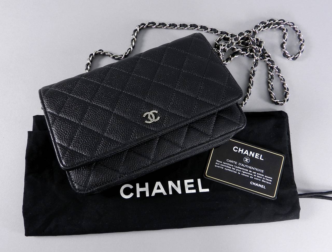 Chanel black caviar leather wallet on chain with silvertone hardware.  Long cross-body strap with 25