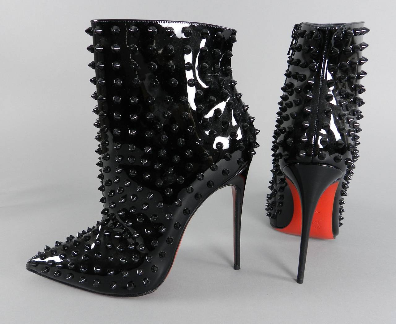 Christian Louboutin Snakilta 120 black patent leather and studded ankle booties. Side zipper, super high stiletto heels, grip soles added.  New - unworn.  Marked size 41.  Original retail $1975+ 

Shipping prices provided are for tracked Ground