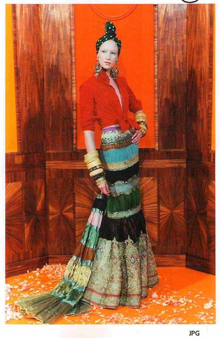 Jean Paul Gaultier Haute Couture outfit. Vintage circa late 1990's. Blouse is silk taffeta with french cuffs and tie at front. Skirt is very heavy and constructed with Indian style gold embroidery, pleated silk, and python skin. Excellent condition