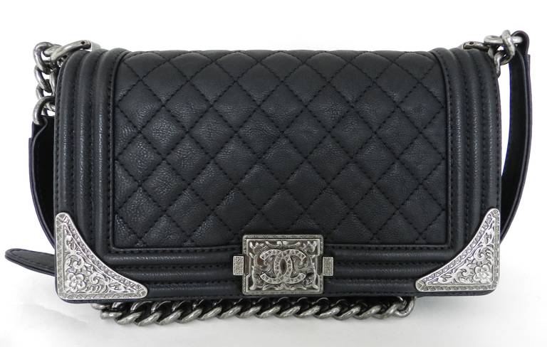 Chanel pre-fall 2014 Dallas collection medium Boy flap bag with embellished sides. Comes with original pricetag, authenticity card, duster, box, and some metal parts sill have the original blue protective plastic that the original owner didn't