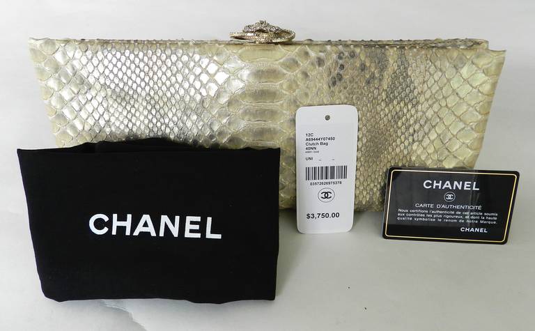 Chanel 2012 Resort runway collection clutch purse. Champagne gold python skin with Swarovski crystal camelia flower clasp. Excellent condition - used once. Comes with authenticity card, original price tag of $3750+, and duster. Measures 12 x 5 x