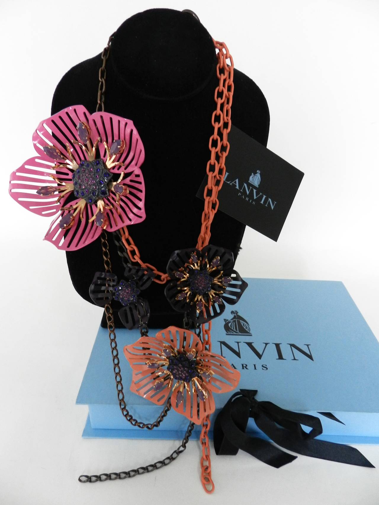 Lanvin pink and brown enamel flower necklace with rhinestones. Excellent condition – worn once. With box and cards. Shortest drop is 10” and longest is 15”. Largest flower is 4.5” x 4”. 

Shipping prices provided are for FedEx Ground to the US.