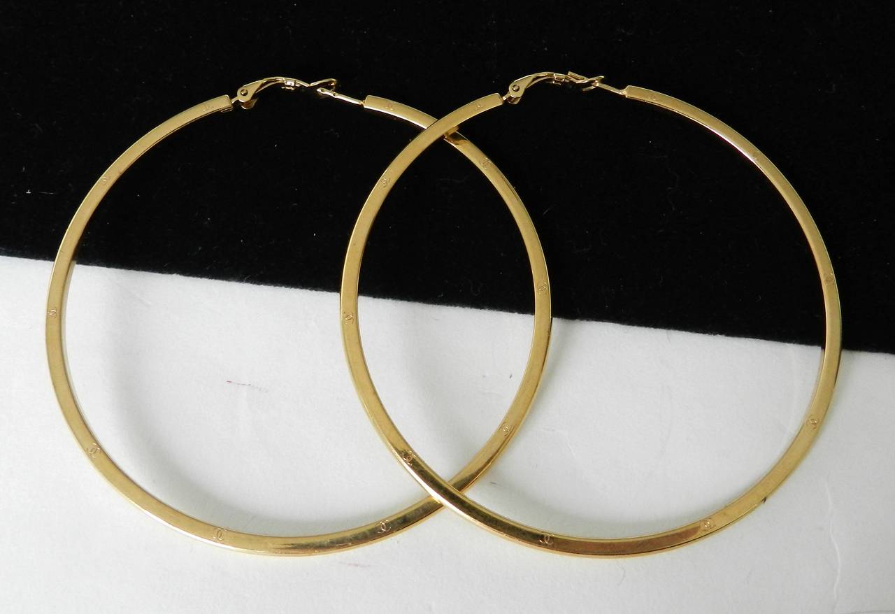 Chanel 2004 spring runway hoope earrings. Pierced with safety lever. Goldtone metal with CC logos on sides. Excellent previously owned condition. Measures about 3