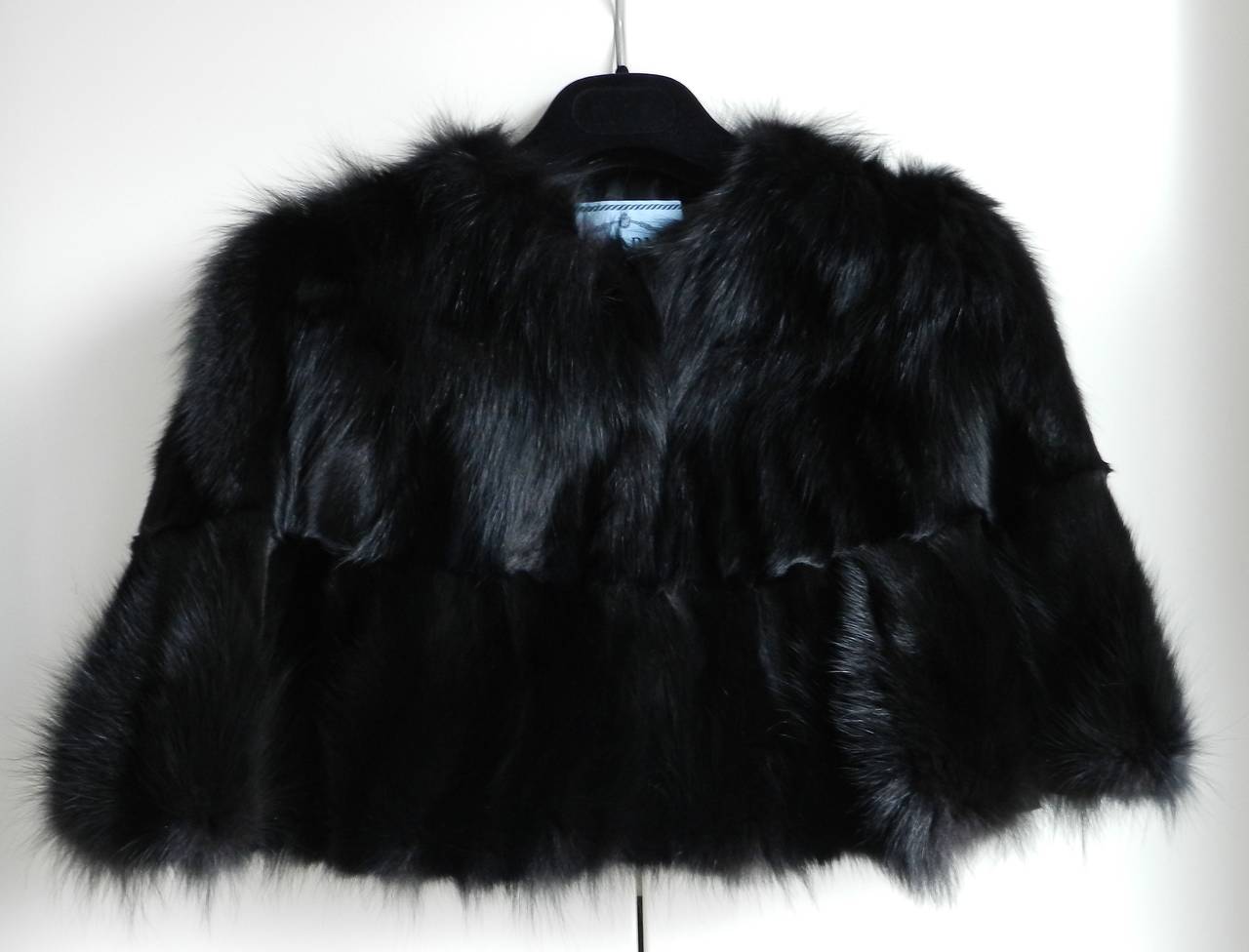 Prada black fox fur stole / capelet. Excellent condition. Fastens at front with hook and eye closures. Back neck to hem is 15