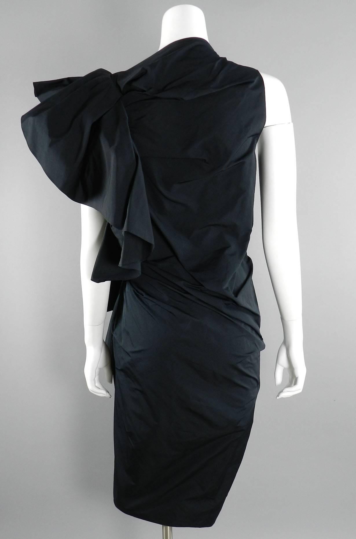 Lanvin black avant garde cocktail dress. 2012 Collection to celebrate 10 years of Alber Elbaz's career as designer at Lanvin. Ruched sheath design with dramatic ruffle detail at left side (shown standing up but can be worn down too). Metal side