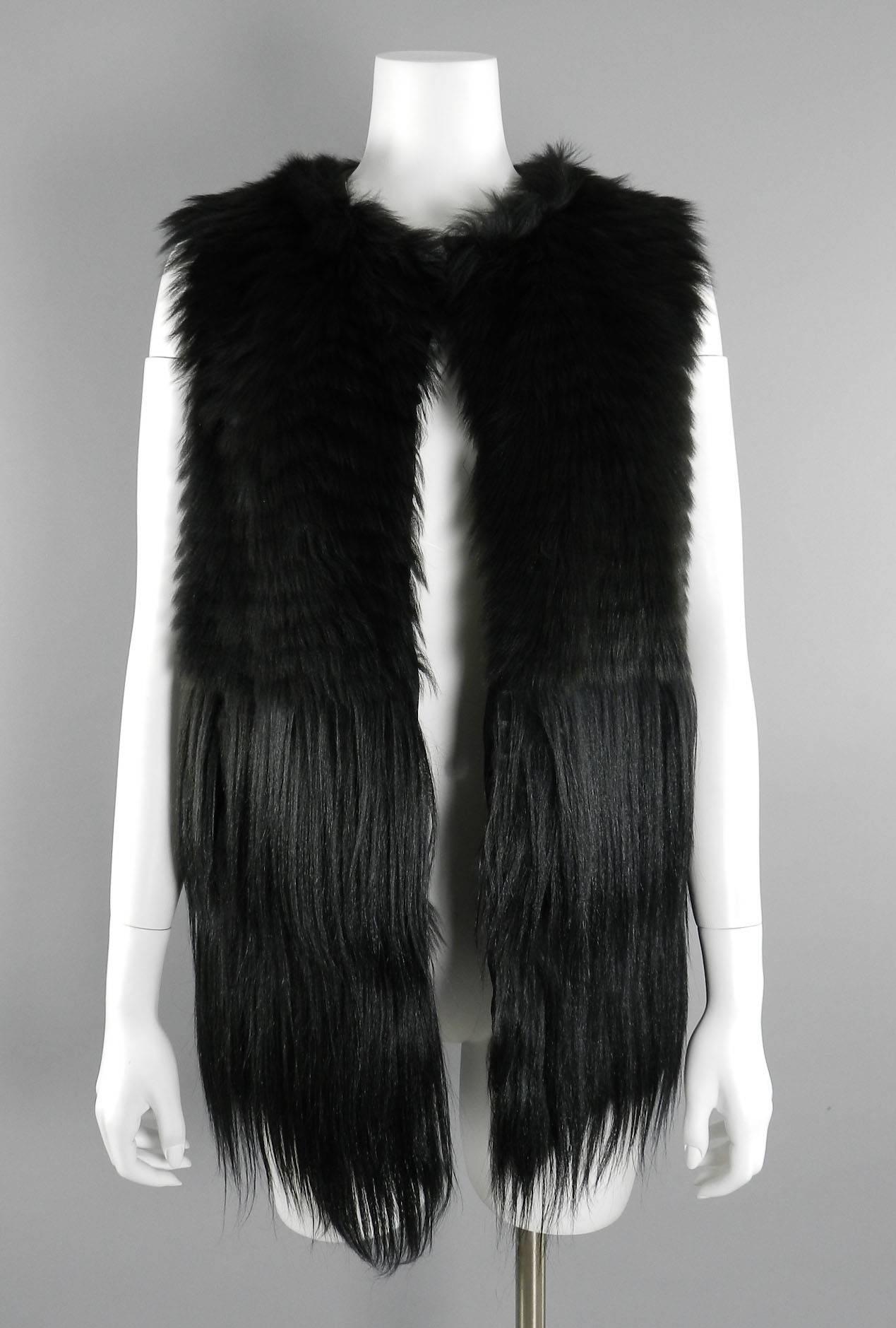 Prada black long dyed sheep fur vest from Fall 2014 collection. Excellent new condition - original retail price tag of $8715+  removed and tucked inside pocket. Lined in 100% silk. Tagged size Prada 40 (small - best for USA 2,4,6). Garment to fit