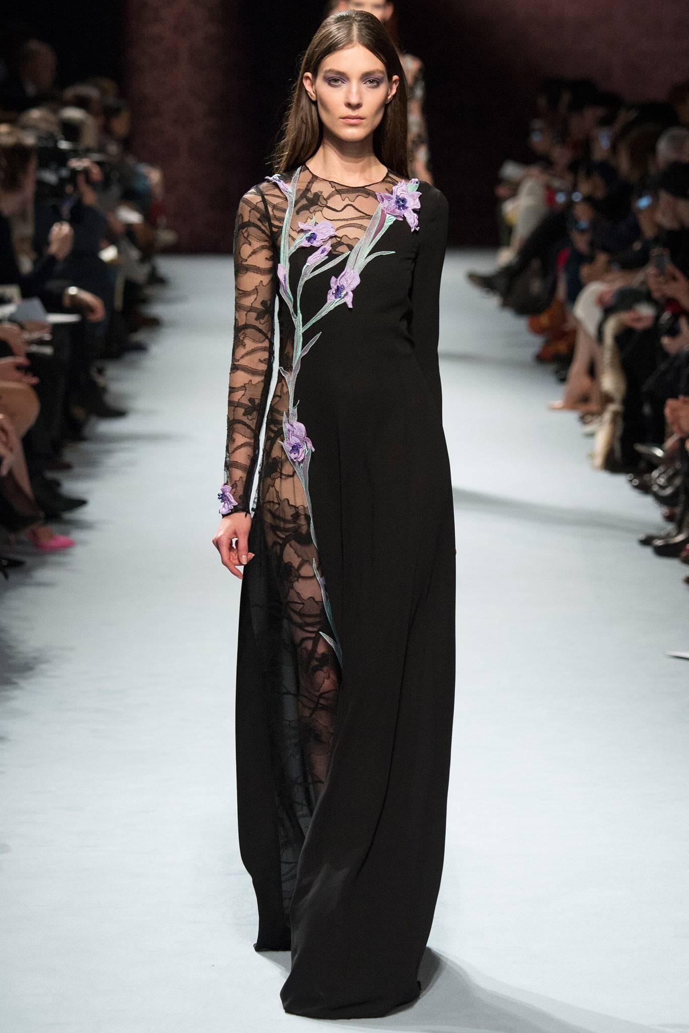 Nina Ricci 2014 black runway gown with sheer black lace and purple embroidered and sequin flowers. Original retail was $5449+. This dress has a 100% silk lining but it can be removed if you would like to wear fully sheer down the side as shown on