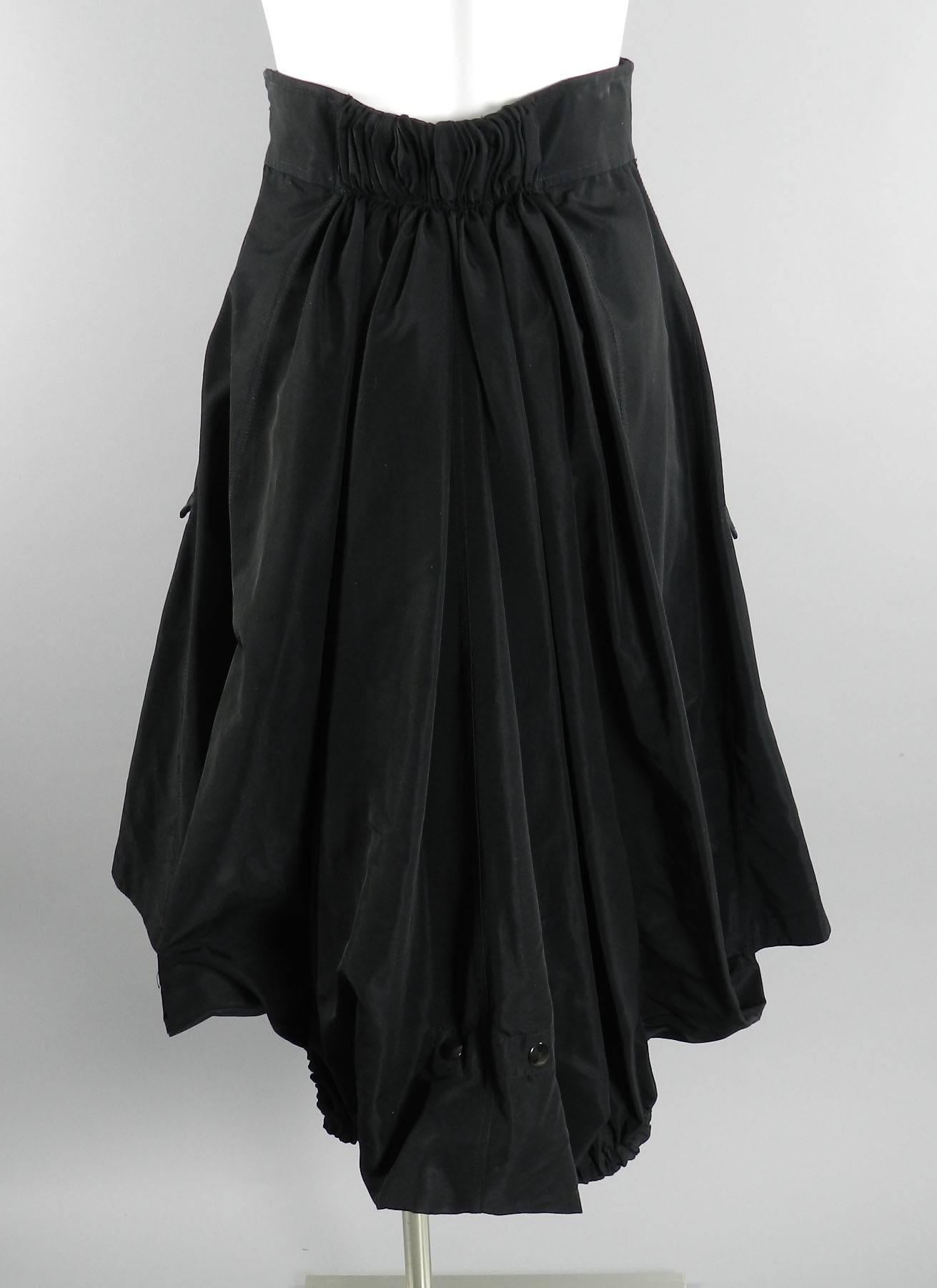 Jean Paul Gaultier Femme black skirt. High waist design with gathered back, buckle at front waist, side metal zipper, and 2 side pockets. Tagged size IT 40  To fit up to 26