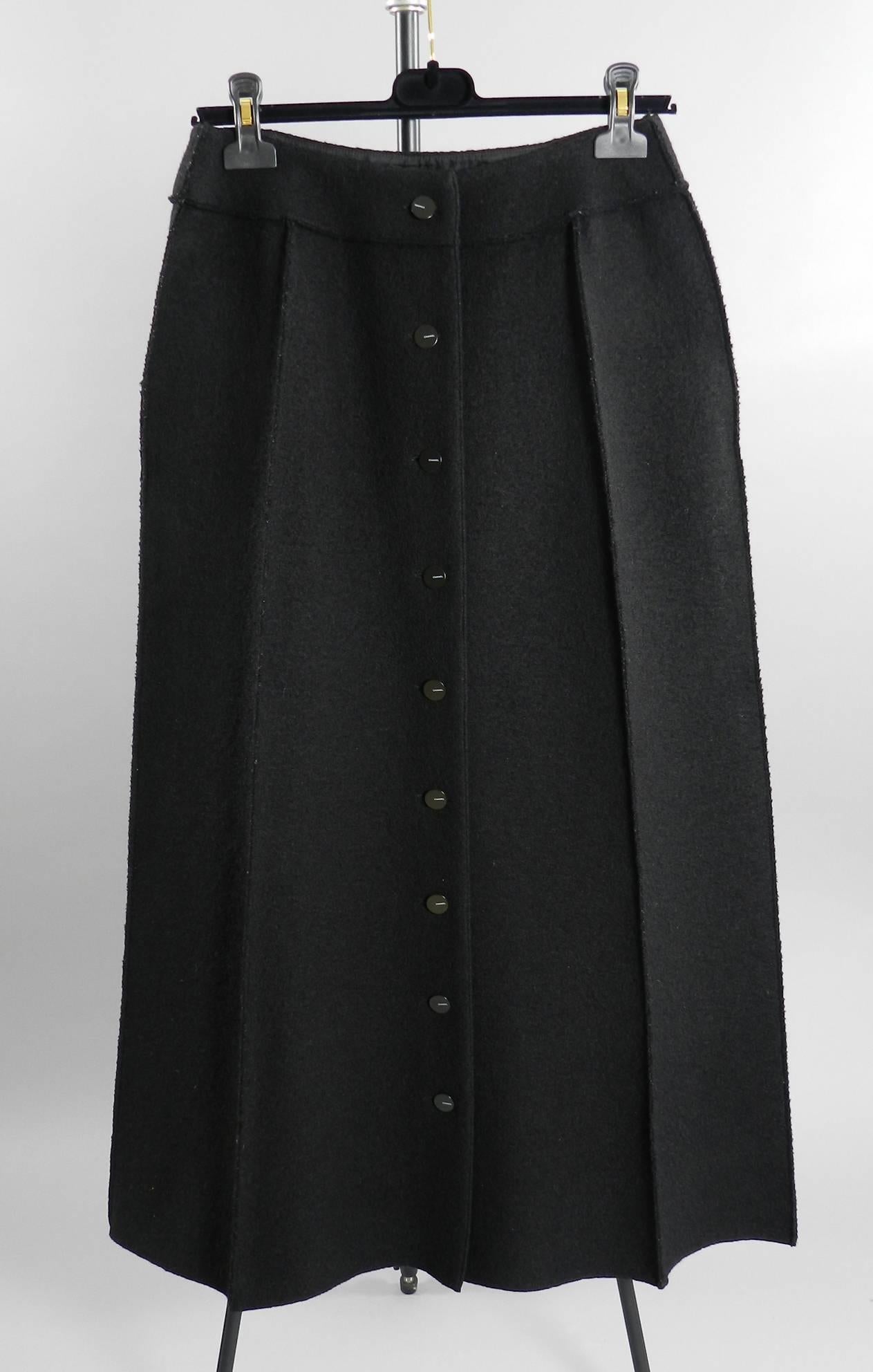 Chanel 1999 fall / winter collection long black skirt. Boiled wool with silk lining and Chanel buttons down back. Excellent pre-owned / vintage condition. Tagged size FR 40 (USA 8). To fit 28