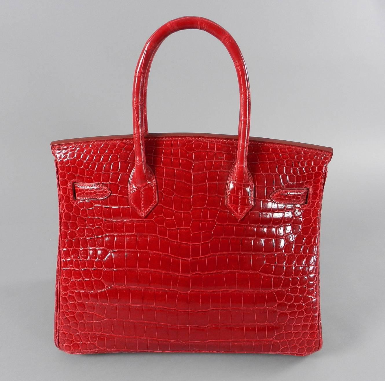 Hermes bright rouge 30cm birkin bag in porosus crocodile and gold hardware.  Excellent pre-owned condition. Comes with lock, clochette, 2 keys, duster, clochette duster, box.  Date stamp for year 2000. Small scratch across front face – not