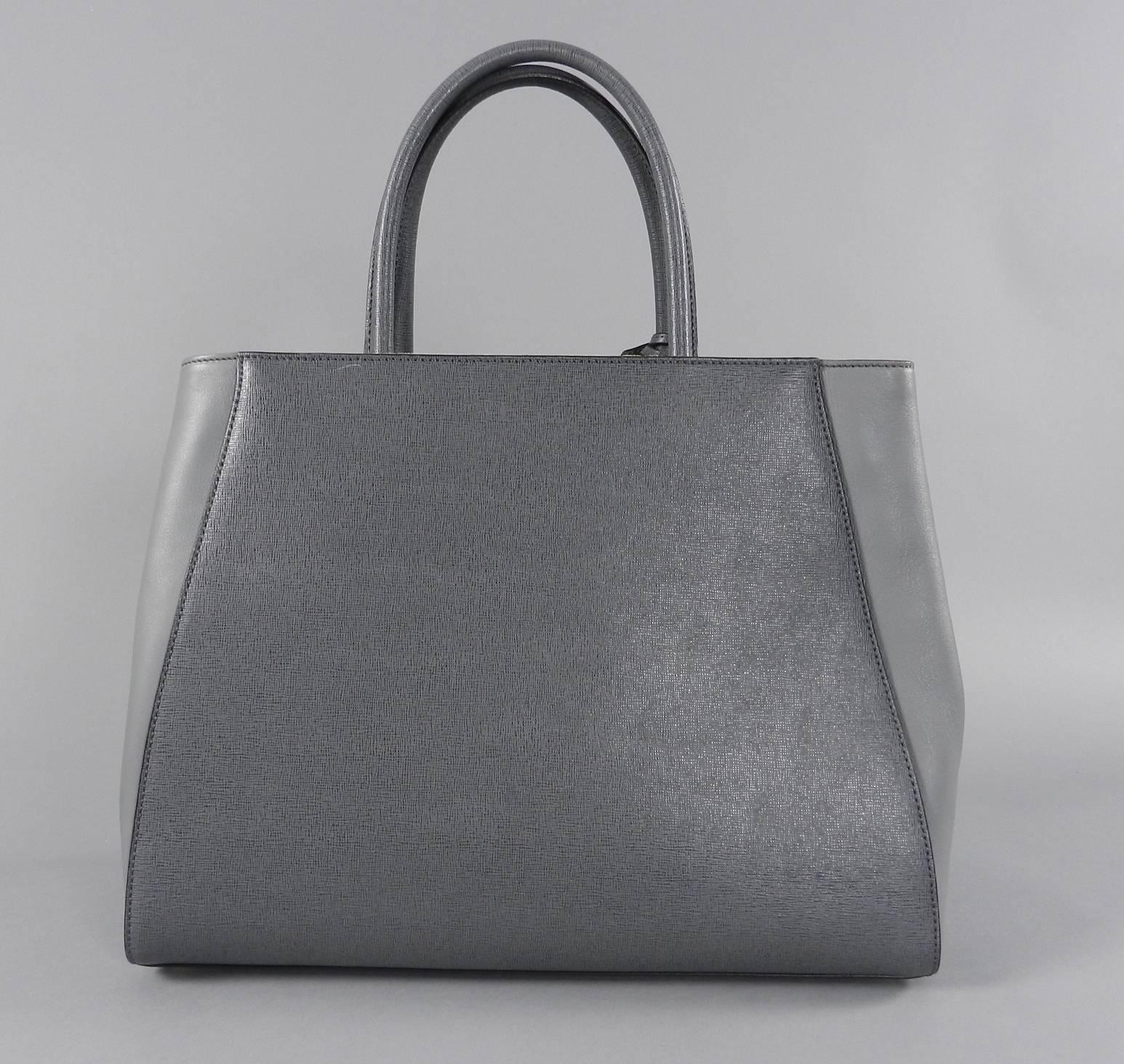 Fendi grey 2 jours medium textured shopper tote bag. Excellent pre-owned condition with cards and duster. Lined with grey striped FF logo fabric.  Double handles.  Body of bag measures about 14 x 10.75 x 6” with a 13” drop strap. 

We ship