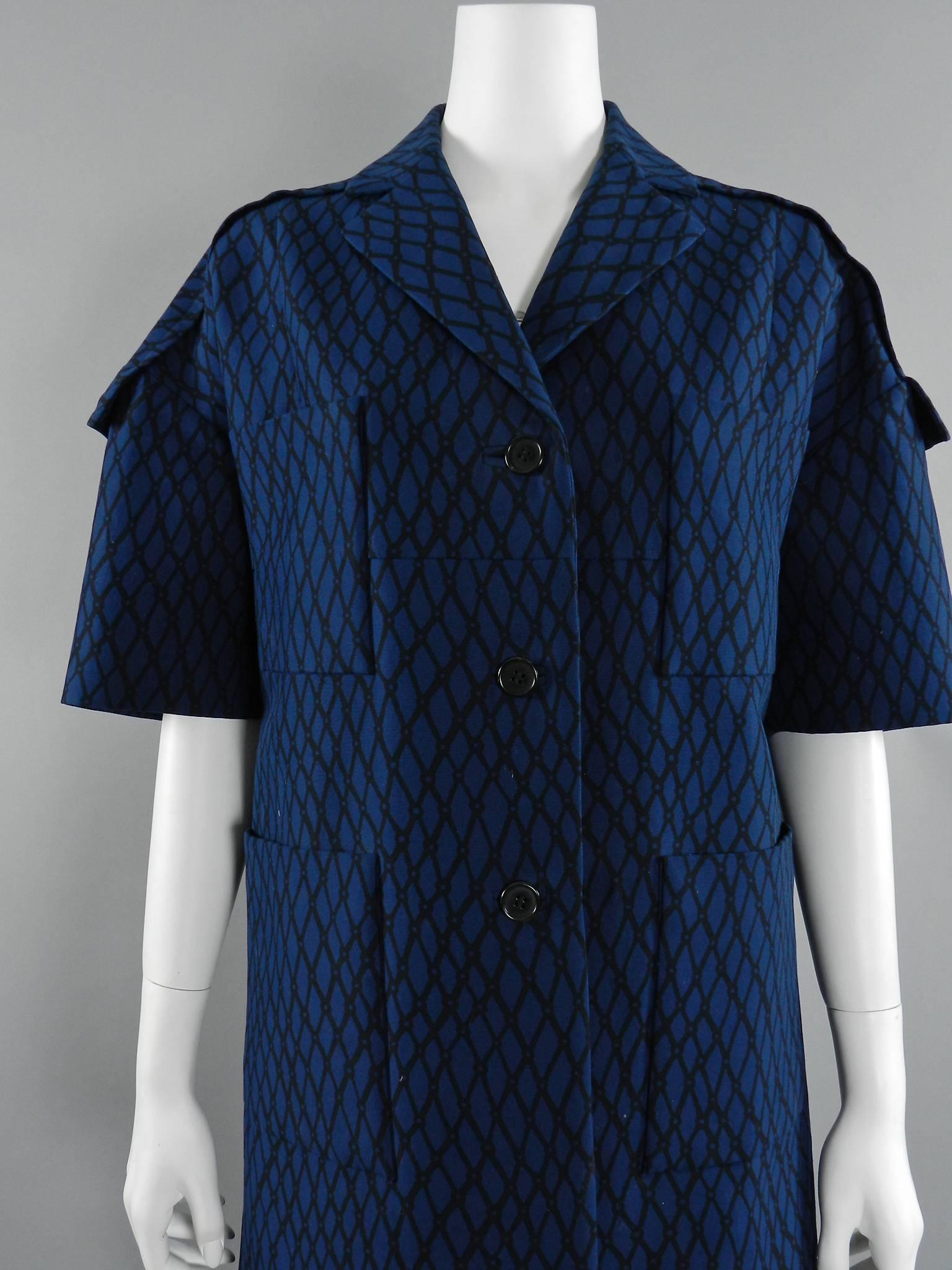 Marni dark blue and black geometric pattern coat. 100% cotton. Straight-cut oversized design with dropped shoulder seams, sort sleeves, and front pockets. Tagged size IT 40 (USA USA 2 / 4). Garment measures 41
