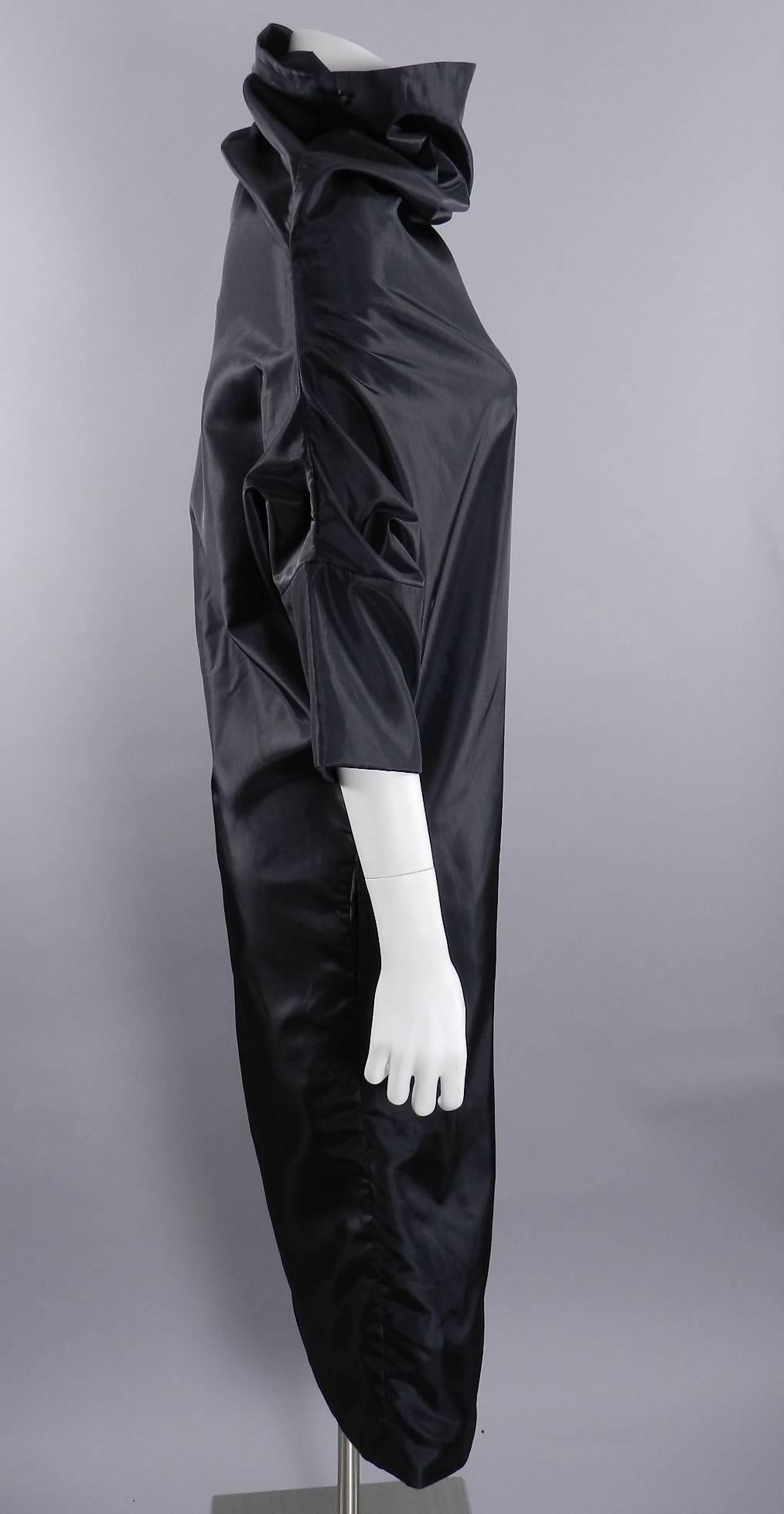 Vintage 1980's Comme des Garcons avant garde black dress. Pull-over style with no zippers or closures. Funnel neck design with half sleeves, 1 side hidden pocket, and raised hem on one side. Excellent clean condition. Tagged size S - best for USA 6.