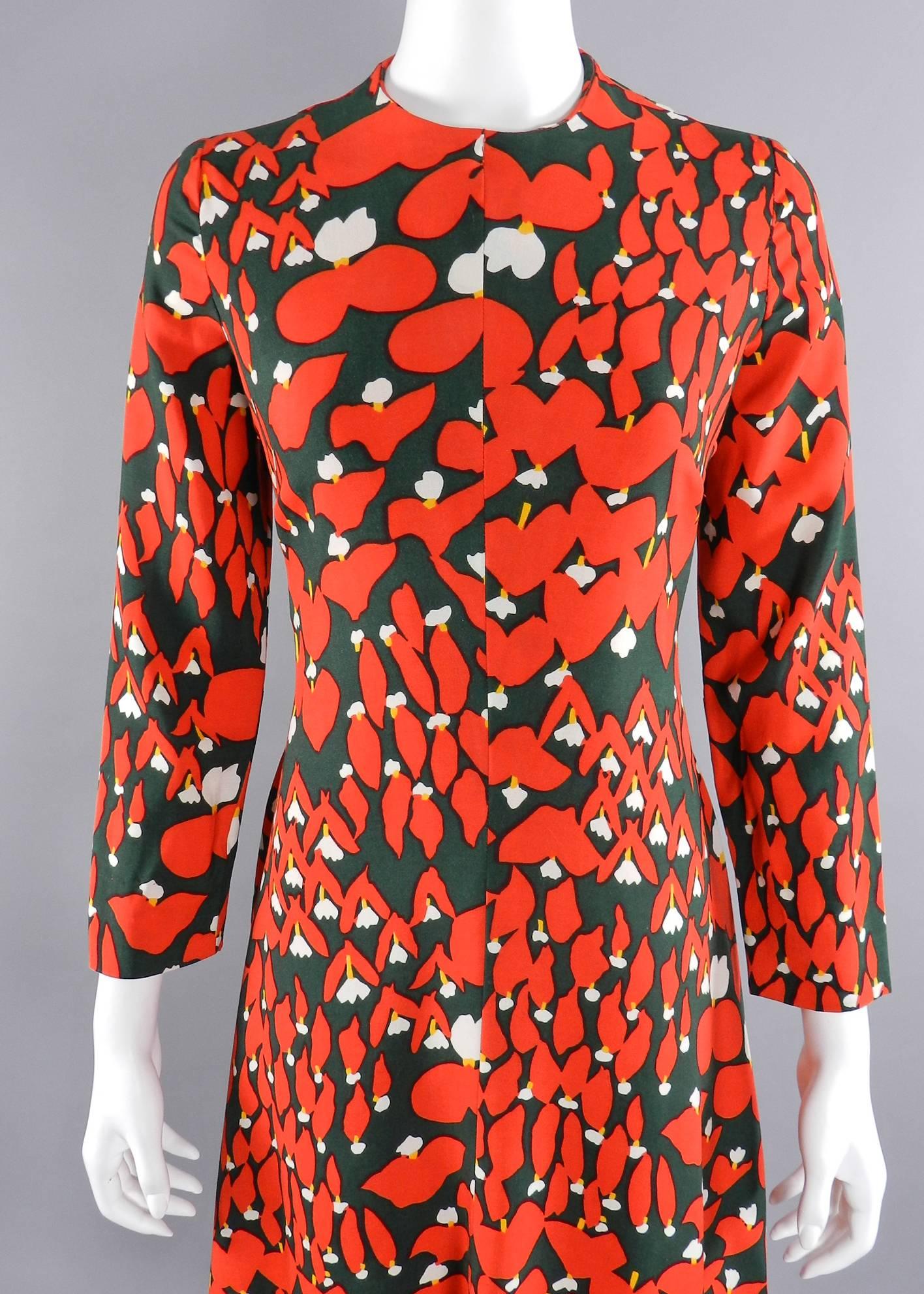 Vintage 1970's Geoffrey Beene dress. Abstract floral pattern in dark green, tomato red, and white. Fully lined. Fabric feels like a cotton / wool blend. Approximate size USA 6. To fit 34