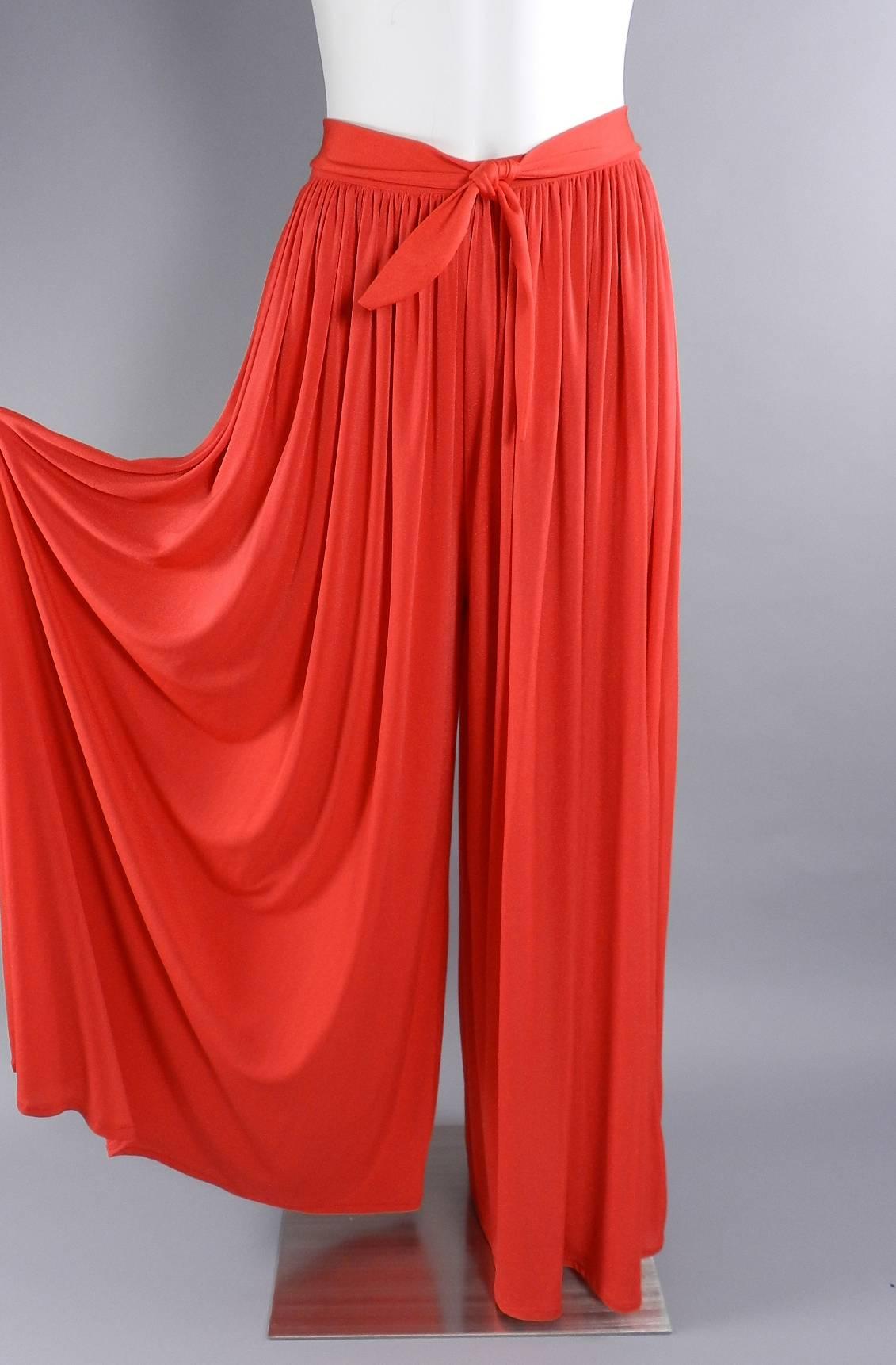 Vintage circa early 1980's Yves Saint Laurent tomato red palazzo pants. Polyester jersey, attached sash belt, centre back zipper. Waist 28