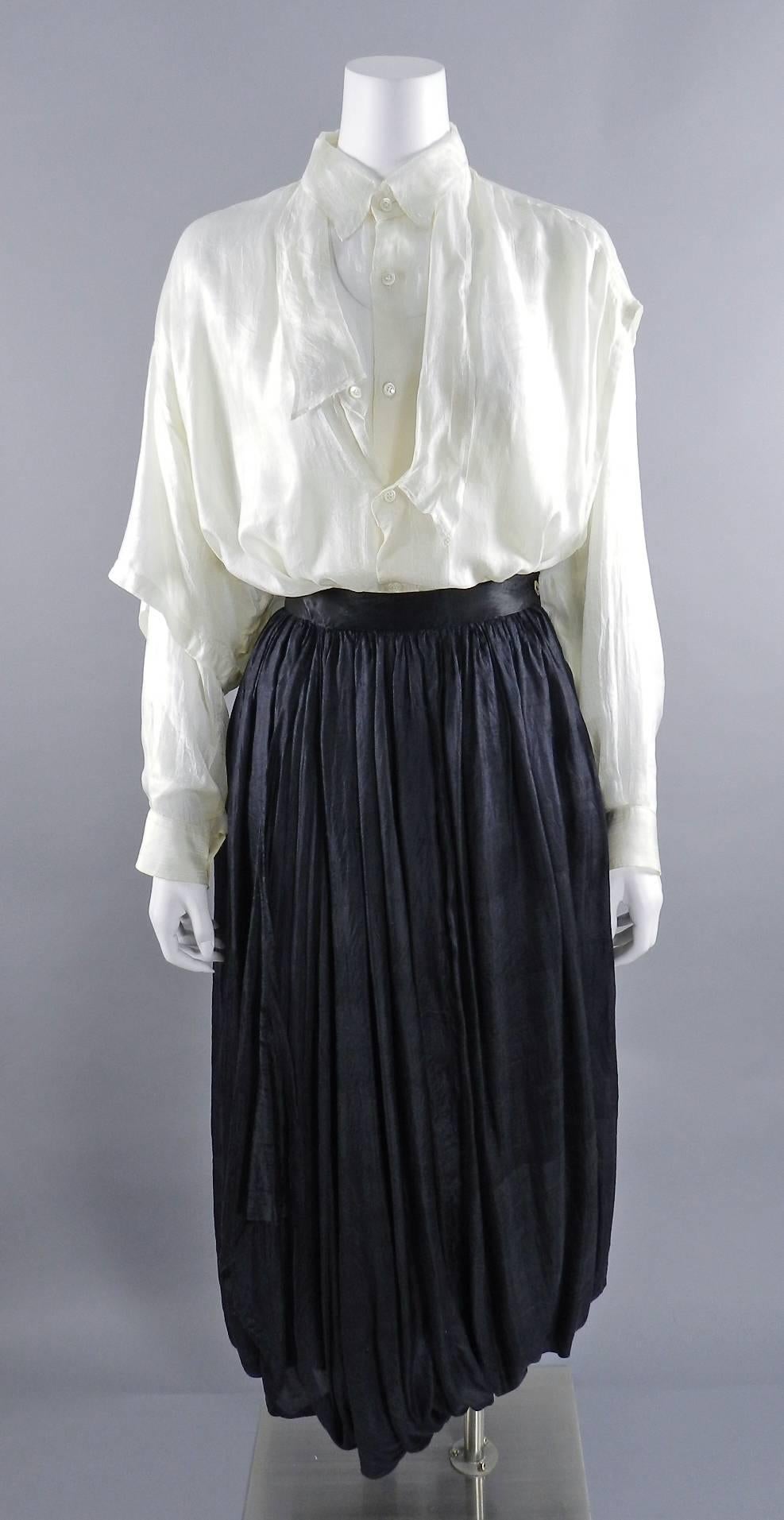 Comme des Garcons vintage circa 1980’s distressed skirt and blouse. Material is very light silk that looks intentionally pulled and distressed. White blouse buttons down front and has a second layer that buttons down over it. Skirt is multi layered,