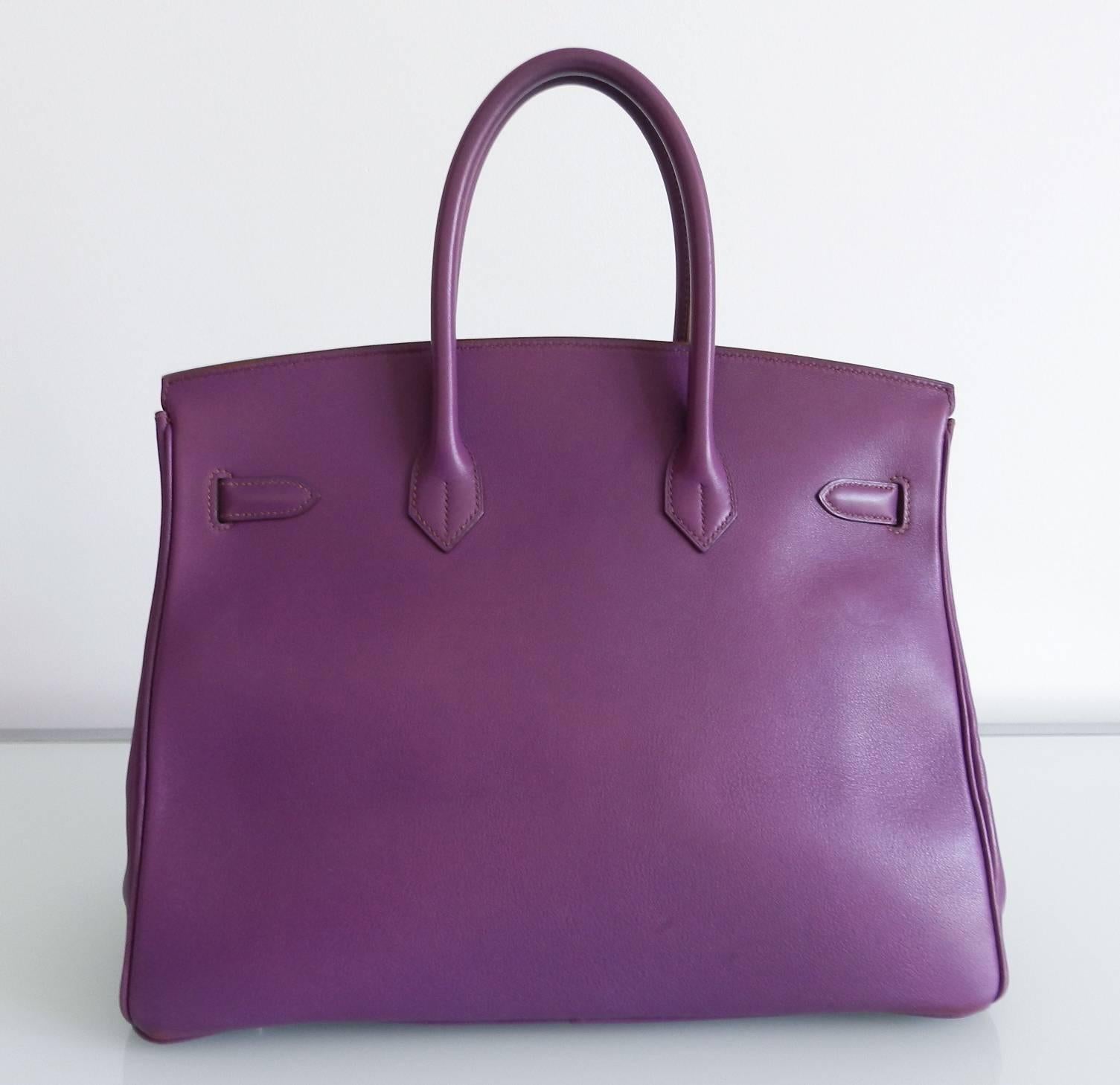 Hermes purple birkin 35cm in ultraviolet, swift leather, and palladium hardware. Date stamp E in square for year 2001.  Very good pre-owned condition with clean interior. Swift leather is smooth and this bag does show some wear at top of handles,