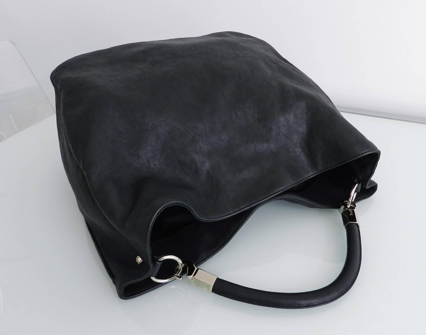 Yves Saint Laurent black roady tote bag. Excellent clean pre-owned condition - used a few times. Interior is lined with black satin. Body of bag measures 14.5 x 14.5 x 6.5