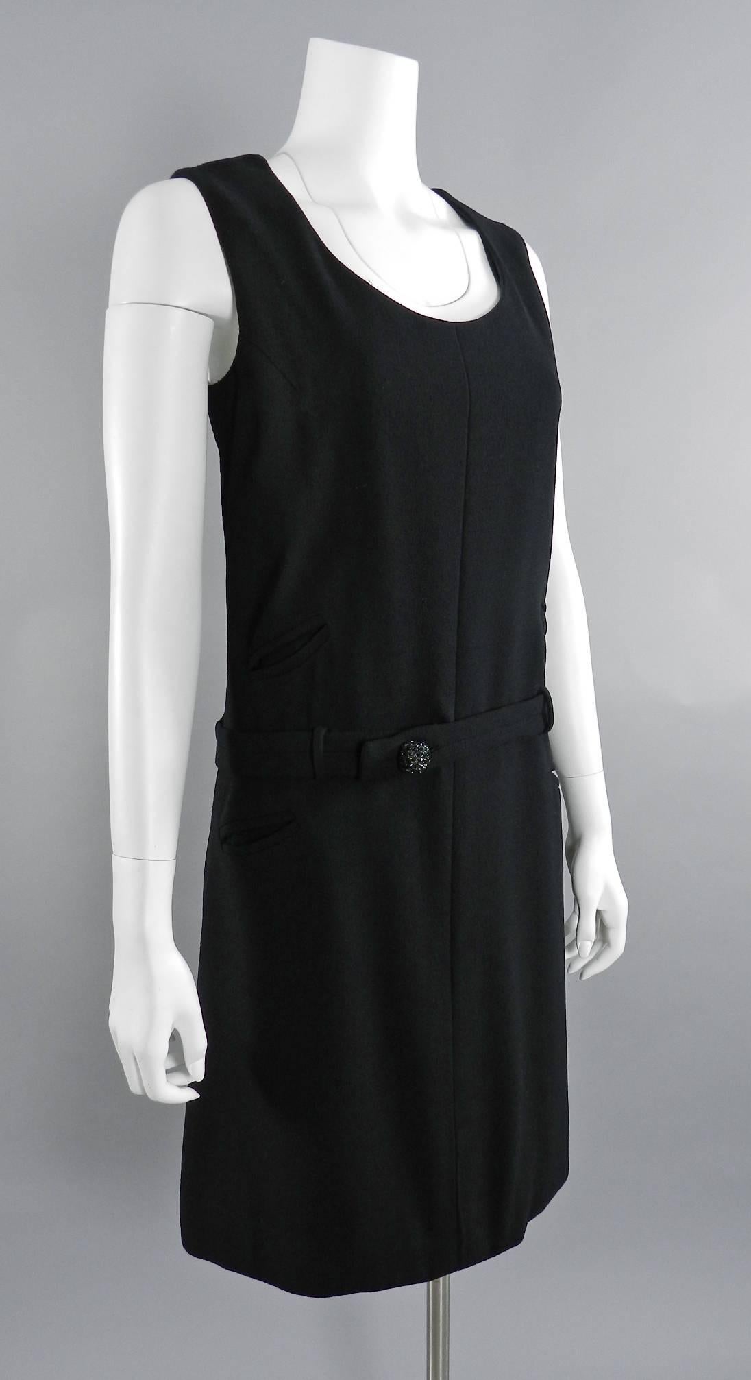 Vintage 1960's Bill Blass black wool sleeveless mod dress. Centre back zipper, drop waist belt, rhinestone jewelled button, lined. Excellent vintage dry-cleaned condition. Approximate size modern USA 10. Garment bust measures 38