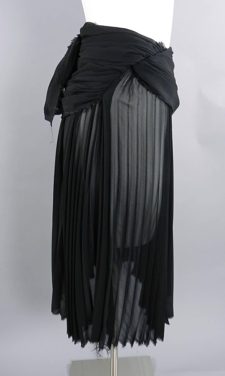 Comme des Garcons vintage sheer black pleated skirt. Metal size zipper, sheer accordion pleat body, and layered waistline. Tagged size SS (USA XS 0-2). Waist measures 26” and is best for 24-26” waist person, semi-full hips, 26” total length.  

We