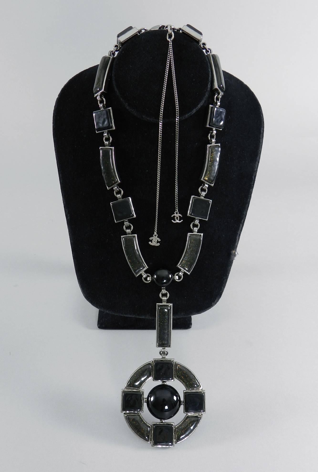 Chanel 09A 2009 Fall black gripoix glass statement necklace. Dark (almost black) grey resin with shimmer glitter and black glass decorate this dramatic cross pendant necklace. Dark silver tone ruthenium metal.  Excellent pre-owned condition - like