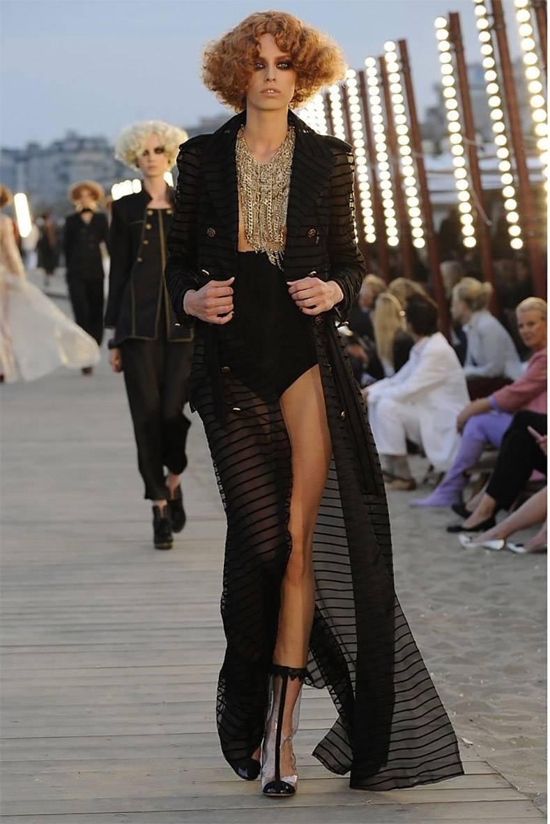Chanel 10c (2010 cruise collection) runway long black jacket. Sheer black fabric with thin velvet stripes and lined with a second sheer fabric. Belted full-length trench design with high slits. An seamstress can easily shorten the jacket. Goldstone
