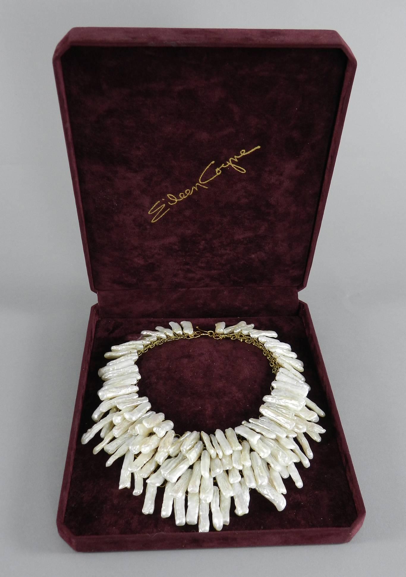 Eileen Coyne designer pearl layered bib necklace. Long freshwater biwa pearls on a chain mesh base. Fastens with hook closure. Unmarked. Comes with original box. Measures 14.5