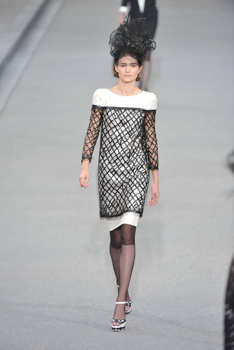 Chanel 09P 2009 Spring runway collection white fully sequin dress with black mesh overlay. 100% silk lined. Small white shimmering sequins cover the body of the dress. There is a black sheer net mesh and thick rubberized overlay. Tagged size FR 38