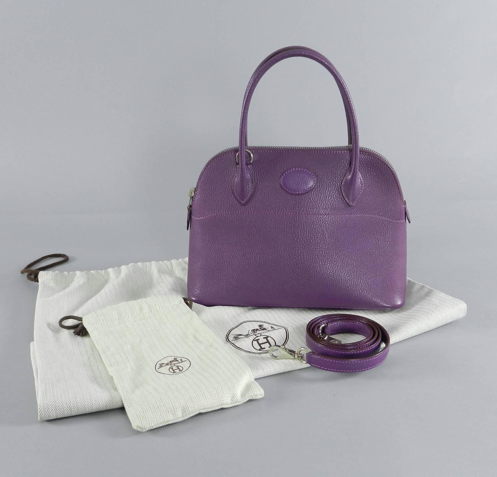 Hermes violet bolide 27 cm. Comes with strap (unused with plastic on it), strap duster, and main duster. Excellent preowned condition with a tiny scuff on one corner and some wear to metal of zipper pull.  Date stamp K in square for year 2007.