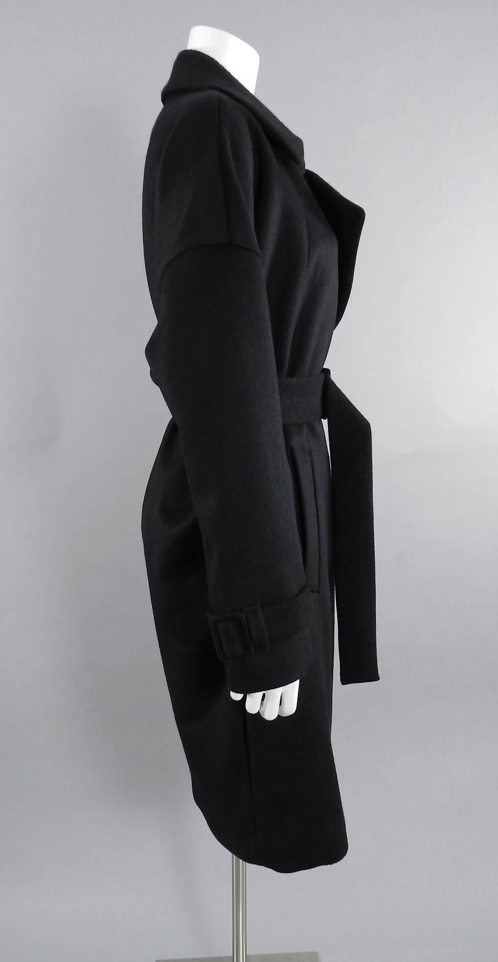 Mugler black wool belted coat. 2 front pockets, belted cuffs, and waist. Fall 2014. Tagged size FR 36 (USA 6) but this coat is cut oversized so can easily fit an 8 too.  Garment measures 46