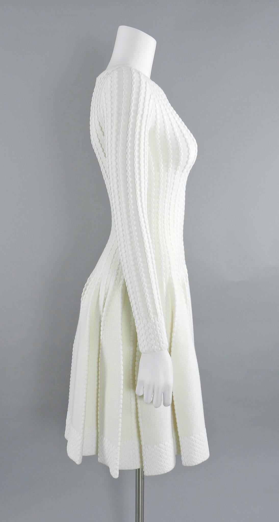 Azzedine Alaia ivory stretch knit bodycon fit and flare dress. Zipper down centre back, long sleeves, textured design. Tagged size FR 38 (Alaia runs small and this is best for a size S - USA 4/6). To fit 34