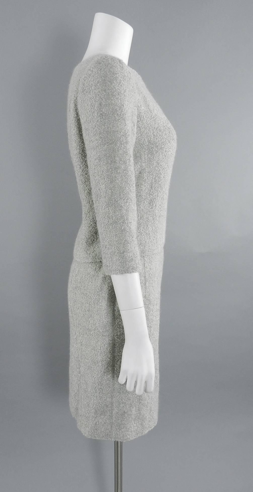 Pierre Balmain Numbered haute couture skirt suit from winter 2000 collection designed by Oscar de la Renta. 1960's inspired design with slim pencil skirt and sheath top. Light dove grey boucle wool. Skirt has two side hip pockets, top has 3/4 length
