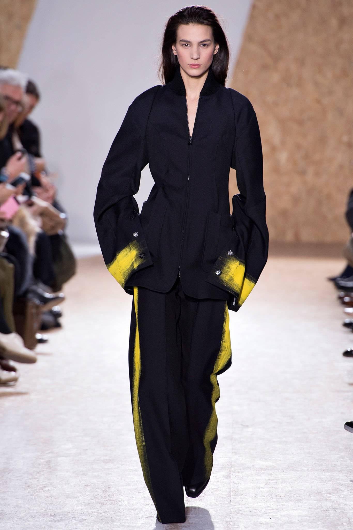 Maison Martin Margiela fall 2013 lead runway jacket. Matching runway trouser available in a separate 1stdibs listing. Black avant garde jacket with zippered front and extra long exaggerated sleeves with yellow painted snap cuffs. Excellent pre-owned
