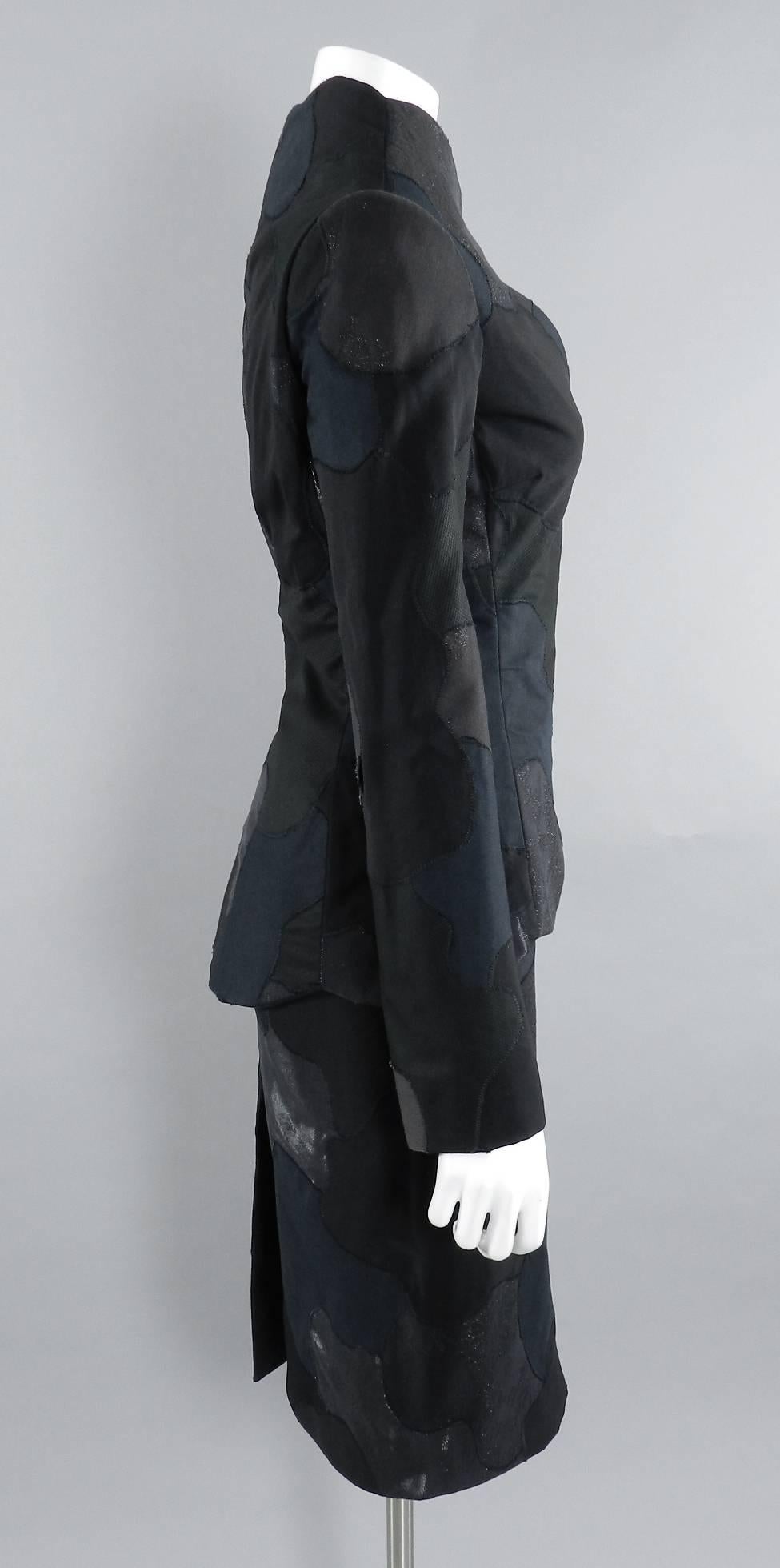 Alexander McQueen black patchwork design skirt suit. Stand away collar, snaps at front, slim pencil skirt. Interior of jacket neckline is faced with silk satin. Jacket and skirt are tagged IT 42 (USA 6) - skirt hip runs all at 35 - 35.5